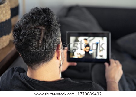 man hand holding using digital tablet watching online master class. learning remotely