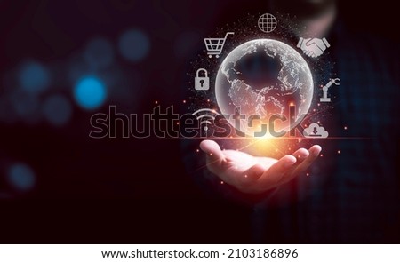 Man hand holding virtual world  with technology icon for metaverse. Globalisation and Digital technology transformation concept. 