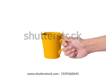 Man hand holding yellow mug of beverage isolated on white background.