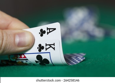 Man Hand Holds Ace With King And Poker Chips