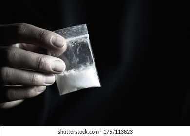 Man Hand Holds Heroin Packet Or Bag With Cocaine Or Another Drugs, Drug Abuse And Danger Addiction Concept