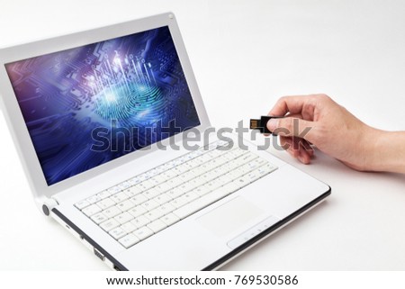 man hand is inserting usb memory card to notebook computer which diplay digital fingerprint of digital security image on white backgrounds, hacking digital finance