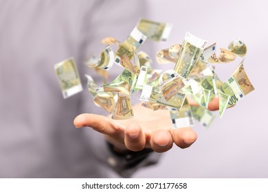 A Man Hand On Blurred Background Holding Cashflow Euro Banknote Bill In Hand