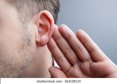 Man With Hand On Ear Listening For Quiet Sound Or Paying Attention