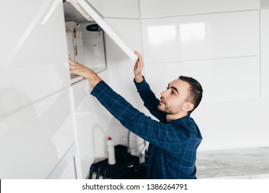 Man Hand Open Kitchen Cupboard With Handle, Close Up