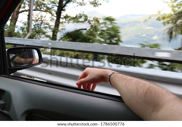 Man Hand outside car Window, feeling the wind. Freedom\
Concept. 