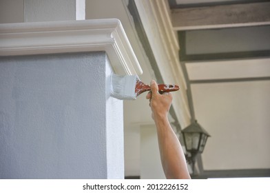 Man Hand Painted A House Pillar With Brush 