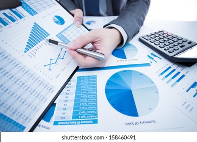 man hand with pen and business report - Shutterstock ID 158460491