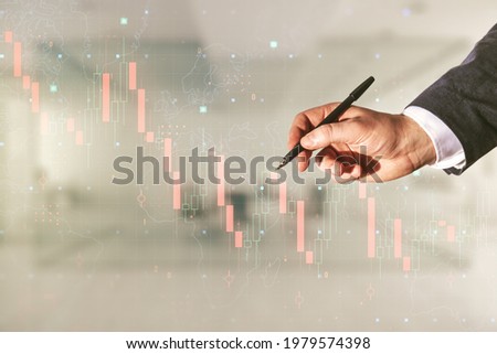 Man hand with pen working with abstract virtual global crisis chart and world map sketch on blurred office background, falling markets and collapse of global economy concept. Double exposure