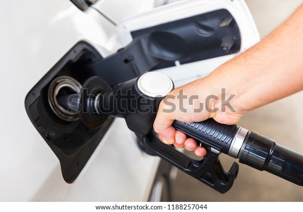 Man hand with\
petrol pump buying gasoline