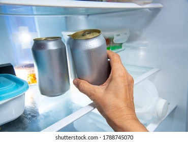 Man Hand Picking Beer Can From Refrigerator