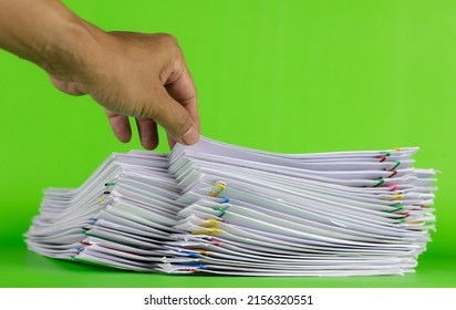 Man Hand Picking Up Paper In Stack Documents On Green Background, Paper Saving Concept, Green Screen Image