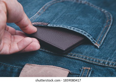 Man Hand Picking Up The Wallet That Put In Jeans.