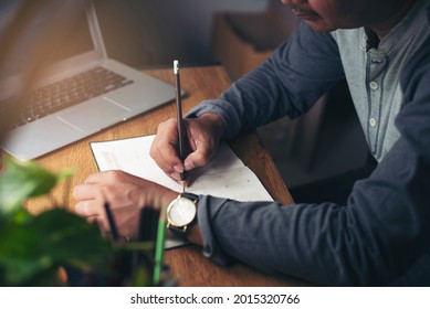 Man Hand of planner writing diary and plan daily appointment on Calendar book. Senior man mark and noted schedule (holiday trip) at business office desk.Calendar reminder event for planner concept. - Powered by Shutterstock