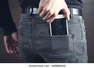 man hand in pocket broken phone