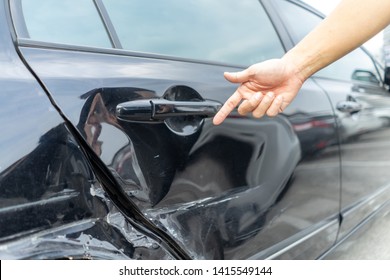 Man hand pointing on car bumper dented broken on black car door. injury car claim for insurance.
Vehicle car crash damage accident on road. Insurance claim concept. - Shutterstock ID 1415549144