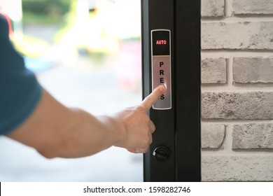 A Man Hand Pressing A Button For Opening Door In A Coffee Shop Or A Restaurant.