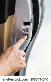 Man Hand Pressing On Child Lock Button At Car's Door.