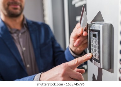 Man Hand Pressing The Security Code Combination And Using Key Card To Unlock The Door