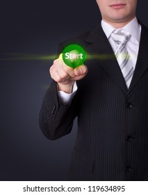 Man hand pressing Start button