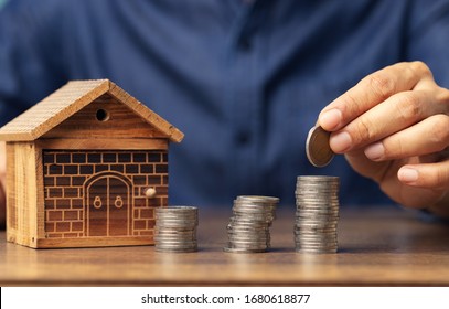 Man Hand Putting Coin To Save Money Buy A House And Super Car, Business Concept.