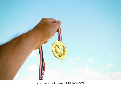 Man Hand Raised Holding Gold Medal Stock Photo 1187654602 