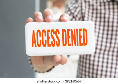 Man hand showing ACCESS DENIED word phone with  blur business man wearing plaid shirt. - Shutterstock ID 392160667