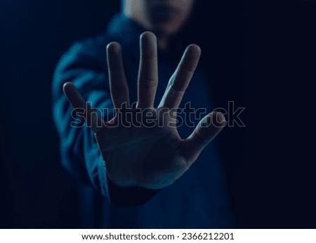 Man hand showing palm gestures stop, concept violence, traffic, refuse, defense, caution, sign stop dark background 