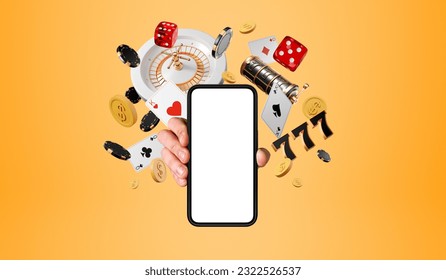 Man hand showing a smartphone mock up blank screen, roulette and casino poker cards with money falling on orange background. Concept of online game, mobile app and gambling - Powered by Shutterstock