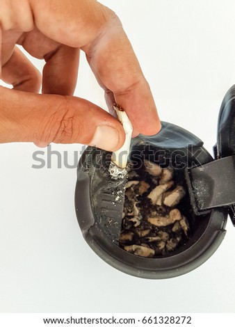 man hand sigaret and ash tree, selective focus of burned cigarette in ashtray,abstract background for no smoking in city and World No Tobacco Day concept.