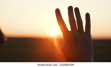 man hand silhouette sunlight. Muslim with man hand sun on light background. christian business love religion concept. christianity and religion belief in god. man sunlight hand reaches for sun god - Shutterstock ID 2163839709