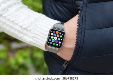 Man hand and smart touch watch with home screen icons apps in pocket 