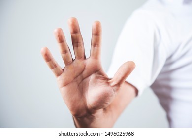 Man Hand Stop Sign On Gray Backgrond