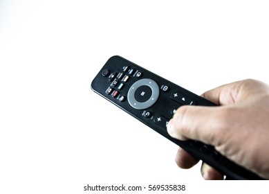 Man hand with television remote control isolated on white background - Shutterstock ID 569535838