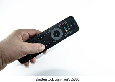 Man hand with television remote control isolated on white background - Shutterstock ID 569535880