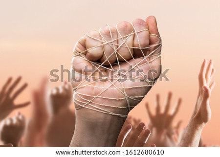 Man Hand Tied With Wire In Crowd