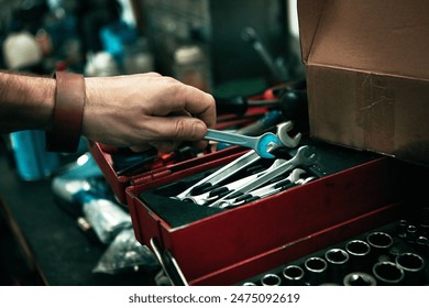Man, hand and tool box for repair service, spanner and mechanic for maintenance in garage. Male person, equipment and wrench for fixing gear or employee at small business, labour and auto workshop