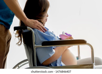 Man Hand Touch Pregnant Woman Shoulder Who Sitting On Wheel Chair,soft Focus,