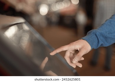 man hand touching interactive touchscreen display kiosk