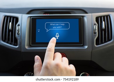 Man hand touching to multimedia system with app personal assistant on screen in car