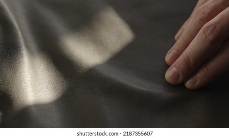 Man hand touching soft leather with sun shining from a window, wide photo - Powered by Shutterstock