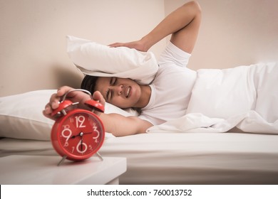 Man hand turns off the alarm clock waking up at morning . 