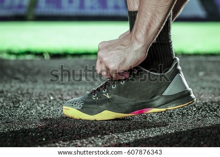 Man hand tying your shoes for running
