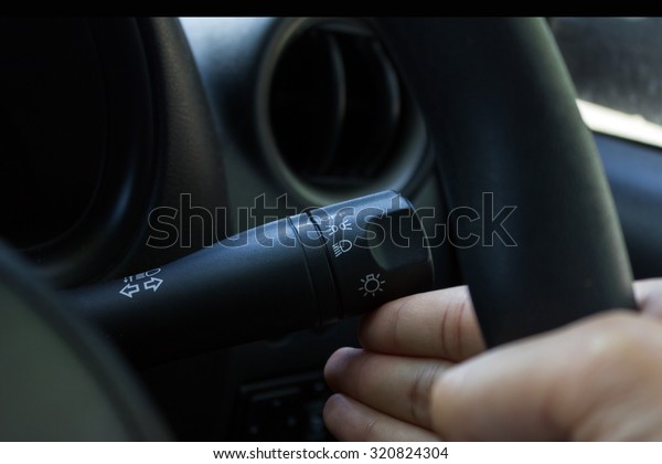 man hand\
use the signal switch. Car interior\
detail.