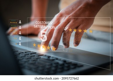 Man hand using computer Notebook with popup five star icon for feedback review satisfaction service,User give rating to service experience on online application.