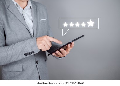 Man Hand Using Digital Tablet With Popup Five Star Icon On Online Application, Customer Review Satisfaction Feedback Survey Concept