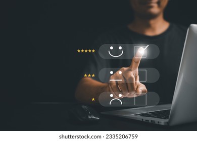 Man hand using laptop computer select 5-star popup with smile face icon for customer feedback, satisfaction survey, and service rating. Business excellence and client performance concept