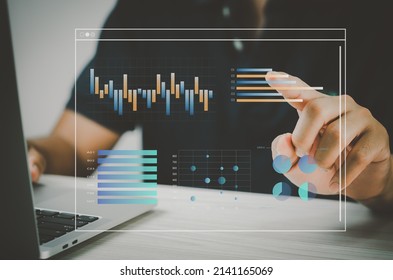 man hand using laptop to working technology.Hand toucing virtual screen graph and chart data analysis and big data business concept.