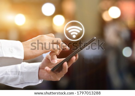 Man hand using mobile smartphone with wifi icon. Idea for business communication social network.