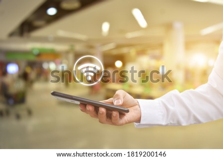 Man hand using mobile smartphone with wifi icon. Idea for business communication social network.
